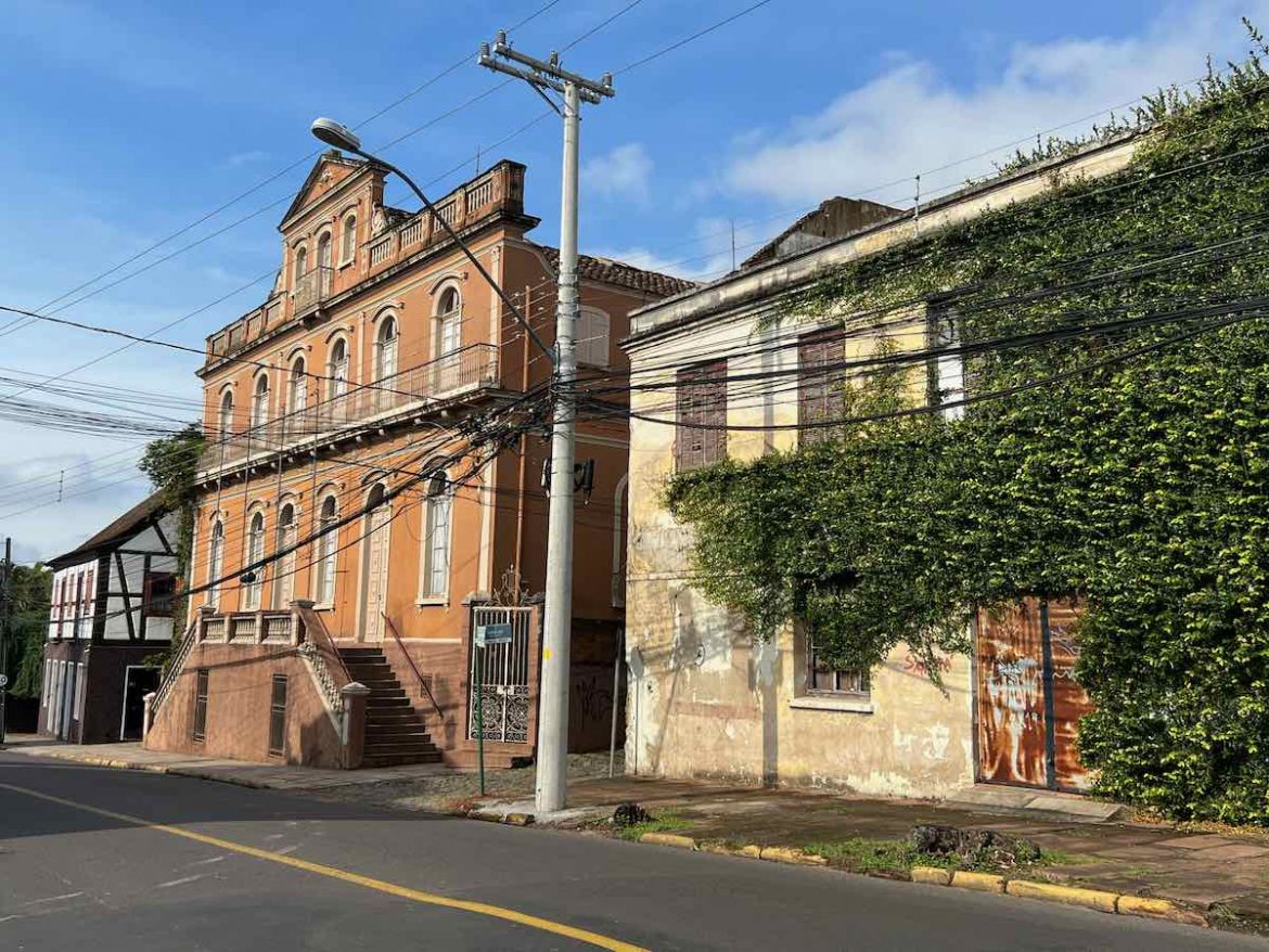 O que fazer em Novo Hamburgo: a fundação scheffel é um prédio laranja e ao lado fica uma antiga construção coberta com folhas